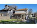 The backyard is fenced and features a covered patio and a manicured lawn at 1521 Pleasant St, Indianapolis, IN 46203