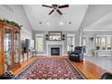 Bright and airy living room with a fireplace, large windows, and hardwood floors under a patterned rug at 17279 Crescent Moon Dr, Noblesville, IN 46060