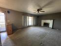 This image shows a living room featuring a fireplace and a large window offering natural light at 2115 Leonard Rd, Martinsville, IN 46151