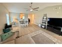 Open-concept living area with a ceiling fan, dining space, and modern decor at 3002 Branch St, Whiteland, IN 46184