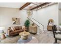 Bright living area featuring vaulted ceilings, wooden beams, modern decor, and stylish furnishings at 307 Baywood Ct # 67, Noblesville, IN 46062