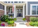 Charming front porch with white columns, American flag, and ample seating at 3641 Shady Lake Dr, Westfield, IN 46074