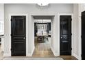 Elegant dining room with a modern chandelier, wood floors, and stylish furnishings at 4915 E 79Th St, Indianapolis, IN 46250