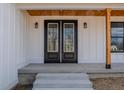 Close up of the double front doors framed by wood columns and inset lights at 5123 Oak Ridge Pl, Columbus, IN 47201