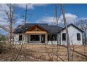 New construction modern farmhouse featuring a wood beam gable and black window trim at 5123 Oak Ridge Pl, Columbus, IN 47201