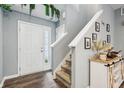 Inviting foyer with hardwood floors, stairs, a white front door, and stylish decorations at 5150 Bramwell Ln, Whitestown, IN 46075