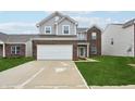 Charming two-story home featuring a two-car garage, brick accents, and a welcoming front lawn at 5150 Bramwell Ln, Whitestown, IN 46075