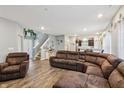Cozy living room with modern decor, featuring a plush brown sectional sofa and plenty of space at 5150 Bramwell Ln, Whitestown, IN 46075