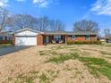 Traditional brick ranch with attached garage, cozy front porch, and classic curb appeal at 5240 Magnolia Dr, Columbus, IN 47203