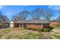 A charming brick home with a neatly manicured lawn and mature trees at 5240 Magnolia Dr, Columbus, IN 47203