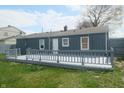 Backyard view with gray deck and partially fenced yard at 5314 W 34Th St, Indianapolis, IN 46224
