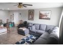 Cozy living room featuring a large gray sectional sofa and tile floors at 5314 W 34Th St, Indianapolis, IN 46224