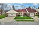 Inviting single-story home with attached garage and well-maintained lawn at 5453 Happy Hollow # 73, Indianapolis, IN 46268