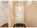 Inviting entryway with wood floors, neutral walls, and a bright white front door at 6145 Crystal View Dr, Indianapolis, IN 46237