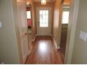 Inviting hallway with wood floors and arched doorways leading to other rooms at 6418 W Oxford Ln, McCordsville, IN 46055