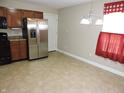 Eat-in kitchen featuring stainless steel refrigerator and chandelier lighting at 6418 W Oxford Ln, McCordsville, IN 46055
