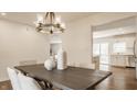 Bright dining room showcases a modern chandelier and a rustic wood table at 6733 Dorchester Dr, Zionsville, IN 46077