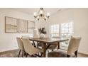 Bright dining room features a modern chandelier and a rustic wood table at 6733 Dorchester Dr, Zionsville, IN 46077