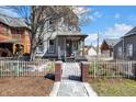 Inviting home with a gated yard, showcasing curb appeal at 827 N Park Ave, Indianapolis, IN 46202