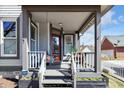 Cozy front porch with a swing and seating, perfect for relaxing at 827 N Park Ave, Indianapolis, IN 46202
