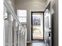 A view of the doorway with wood floors and white railing at 9694 Angelica Dr, Noblesville, IN 46060