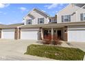 Inviting townhome featuring a two-car garage, charming curb appeal, and a classic facade with stylish accents at 9694 Angelica Dr, Noblesville, IN 46060