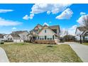 Lovely exterior view of a home with a well-kept lawn and a long driveway leading to a multi-car garage at 10237 Sand Run Ln, Fortville, IN 46040