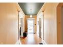 Bright hallway with gleaming hardwood floors and decorative molding throughout the home at 110 E Hendricks St, Shelbyville, IN 46176