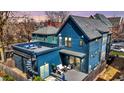 Backyard view showcasing a deck, outdoor seating, and spiral staircase leading to a rooftop terrace at 1238 Alabama St, Indianapolis, IN 46202