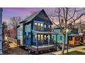Charming blue two-story home with a covered front porch and manicured landscaping at 1238 Alabama St, Indianapolis, IN 46202