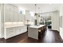 Modern white kitchen featuring a large island, stainless steel appliances, and hardwood floors at 1238 Alabama St, Indianapolis, IN 46202