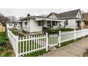 Quaint home with a white picket fence, covered porch, and well-maintained landscaping at 1252 Kappes St, Indianapolis, IN 46221