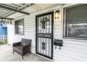 Close-up of front door and covered porch with stylish exterior lighting at 1252 Kappes St, Indianapolis, IN 46221