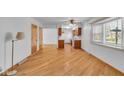 Inviting dining area featuring hardwood floors, a ceiling fan, and a large window for natural light at 1330 N Gibson Ave, Indianapolis, IN 46219