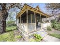 Inviting home showing a quaint, covered porch with detailed woodwork and a cozy chair at 1542 Maple Ave, Noblesville, IN 46060