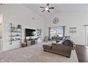 Bright living room with vaulted ceilings, plush carpet, a cozy sectional, and large windows at 16566 Branham Dr, Fishers, IN 46040