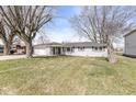 Charming single-story home with a well-maintained lawn and attached two car garage at 1710 Bittersweet Dr, Anderson, IN 46011