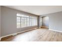 Bright living room with large window, wood flooring, and neutral paint at 220 Monroe St, Indianapolis, IN 46229