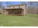 Spacious backyard featuring a covered patio ideal for outdoor entertaining and relaxation at 2539 S Edgewood Cv, Martinsville, IN 46151