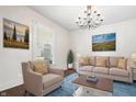 Bright living room featuring neutral decor, artwork, and a cozy seating arrangement at 2748 Carrollton Ave, Indianapolis, IN 46205
