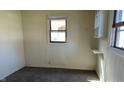 Bedroom with neutral walls, carpet, a window and a small amount of storage at 318 Chester St, Anderson, IN 46012