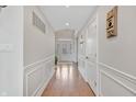 Inviting hallway with detailed molding and hardwood flooring at 3240 Wildlife Trl, Zionsville, IN 46077