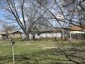 View of the backyard with neighboring houses, fence and sparse landscaping at 3314 Argyle Ct, Indianapolis, IN 46226
