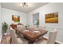 Traditional dining room features wood table with upholstered chairs, complemented by elegant decor and natural light at 3445 N Olney St, Indianapolis, IN 46218