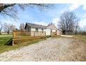 Exterior of house with a wooden deck, gravel driveway, small patches of green grass, and a storage shed at 3721 S 575 W, Trafalgar, IN 46181