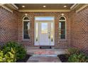 Detailed front entry showcasing brick facade, decorative glass door, and sidelights at 400 S Prairie Trce, Muncie, IN 47304