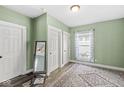 Cozy bedroom featuring hardwood floors, natural light, and closet space at 412 N Riley Ave, Indianapolis, IN 46201