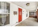 Inviting front porch featuring a red front door and classic architectural details at 412 N Riley Ave, Indianapolis, IN 46201
