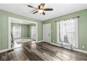 Bright living room with hardwood floors, ceiling fan, and natural light at 412 N Riley Ave, Indianapolis, IN 46201