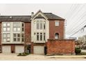 Brick townhome featuring attached garages and well-maintained landscaping with an inviting facade at 503 Lockerbie N Cir, Indianapolis, IN 46202